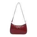 Chic burgundy patent leather hobo bag with gold bow accent for trendy shoulder wear - Red