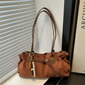 Brown faux suede tote bag with vintage bead charm shown in warm natural window light - Brown
