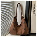 Brown faux suede tote bag with floral cutout patterns and adjustable shoulder strap - Coffee