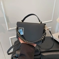 Minimalist black woven chain crossbody bag with asymmetric flap and geometric ornament - Black