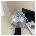 Metallic silver drawstring bucket bag with minimalist cord strap on a clean desk - Silver