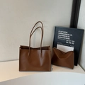 Minimalist deep brown large leather tote bag with matching pouch on white surface - Brown
