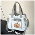 Detail view of the water-resistant nylon fabric and cartoon capybara print on the tote bag - Light Blue