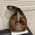 Vintage brown leather hobo bag featuring a silver rivet star pattern and wide strap - Brown