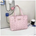 Pink tote bag with black bow print, golden metal clasp, and long shoulder straps - Pink