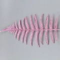 Macro shot of single pink glitter fern leaf ornament for Christmas tree decoration - Pink