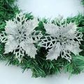 Silver glitter poinsettia artificial flowers on green Christmas wreath decor - Silver