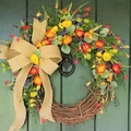 Rustic floral wreath with colorful faux flowers and burlap bow on a dark green door - Flower Style 1