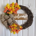 Detail of tulip wreath with natural grapevine base and rustic burlap bow on white door - Orange Red