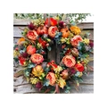 Autumn wreath with pumpkins and orange dahlias hanging on a rustic wooden fence - Multicolor