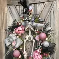 Halloween skeleton wreath with pink peonies and striped bows on a rustic wood door - Pink Skeleton