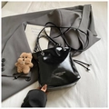 Detail of black glossy bucket bag with chain handle and cute brown bear charm - With Pendant / Black