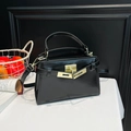 Classic black shiny leather trapezoid handbag with gold rotating lock and top handle - Black