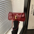 Chic burgundy patent leather underarm bag with gold metal buckle closure - Red