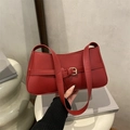 Chic red faux leather baguette bag with a gold buckle and adjustable shoulder strap - Red