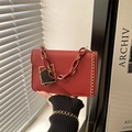 Retro red crossbody bag with matte finish, golden chain, and geometric clasp detail - Red