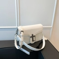 White lychee leather shoulder bag with vintage metal cross lock and chain strap detail - White
