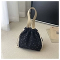 Detail of black corduroy bucket bag with butterfly prints and cream woven handles - Black
