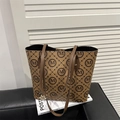 Brown tote bag with circle M monogram print, slim shoulder straps and gold metal pendant - Brown