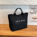 Minimalistische zwarte tote bag met witte TOTE BAG tekst en matte textuur voor dagelijks - Zwart