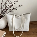 White woven texture tote bag with double shoulder straps on a wooden table setup - White