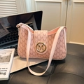 Borsa a spalla rosa con monogramma M e chiusura dorata in un contesto lifestyle urbano - Rosa