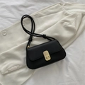 Minimalist black faux leather shoulder bag with gold clasp and knotted strap detail - Black