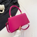 Minimalist rose red leather crossbody bag with curved handle and golden hardware details - Rose Red