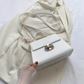 Minimalist white leather trapezoid handbag with gold T-bar lock and adjustable strap - White