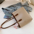 Minimalist beige tote bag with brown trim and cute pink plush charm on a denim background - With Pendant / Khaki