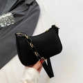 Minimalist black crossbody bag featuring crocodile embossed pattern and gold chain strap - Black