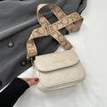 Chic beige crossbody bag with wide patterned strap and embossed fashion text detail - Off White