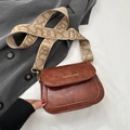 Brown leather saddle bag with wide patterned shoulder strap and gold fashion logo - Brown