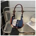 Detail of color-block patchwork canvas hobo bag with knotted leather handle and metal clasp - Blue
