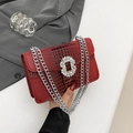 Detail of red crocodile pattern handbag with luxury rhinestone buckle and silver chain - Red
