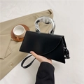 Structured black leather handbag featuring a unique silver metallic handle and shoulder strap - Black