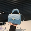 Light blue quilted mini bag with golden heart lock and scrunchie handle strap - Blue