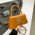 Vintage-Handtasche aus ingwergelbem Leder mit großem goldenem Metalllogo und Tragegriff - Braun