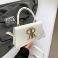 White faux leather square handbag featuring gold crown RR logo and slender shoulder strap - White