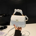 White quilted crossbody bag with golden heart clasp and trendy ruffled top handle - White
