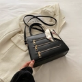 Black leather crossbody tote with gold zippers and scarf handle detail for women - Black
