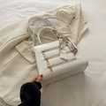 White box-shaped crossbody bag with gold zippers and decorative silk scarf on handle - White