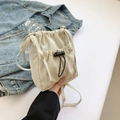 Minimalist cream white drawstring crossbody bucket bag with front pocket design - White