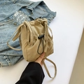 Minimalist light khaki nylon bucket bag with adjustable drawstring and sleek fabric strap - Khaki