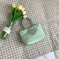 Mint green bucket handbag with heart-shaped smiley patch and durable nylon material - Blue