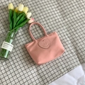 Pink minimalist bucket bag with a heart-shaped smiley patch on checkered background - Pink