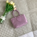 Compact purple nylon bucket bag featuring a stitched heart smiley patch for casual wear - Purple