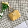 Minimalist yellow canvas bucket bag with heart patch and stylish tube handles - Yellow