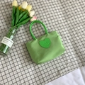 Light green nylon bucket bag with a dark green leather heart smile face design - Green