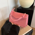 Pink striped woven crossbody bag with knotted rope handle and gold metal clasp - Pink